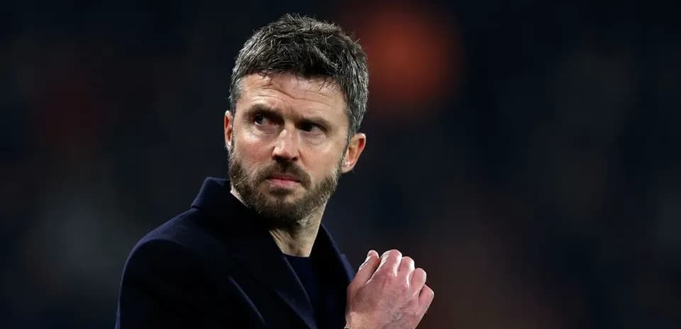 Coach looking thoughtful on the sidelines