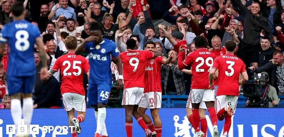 Players celebrating a goal with fans in stadium