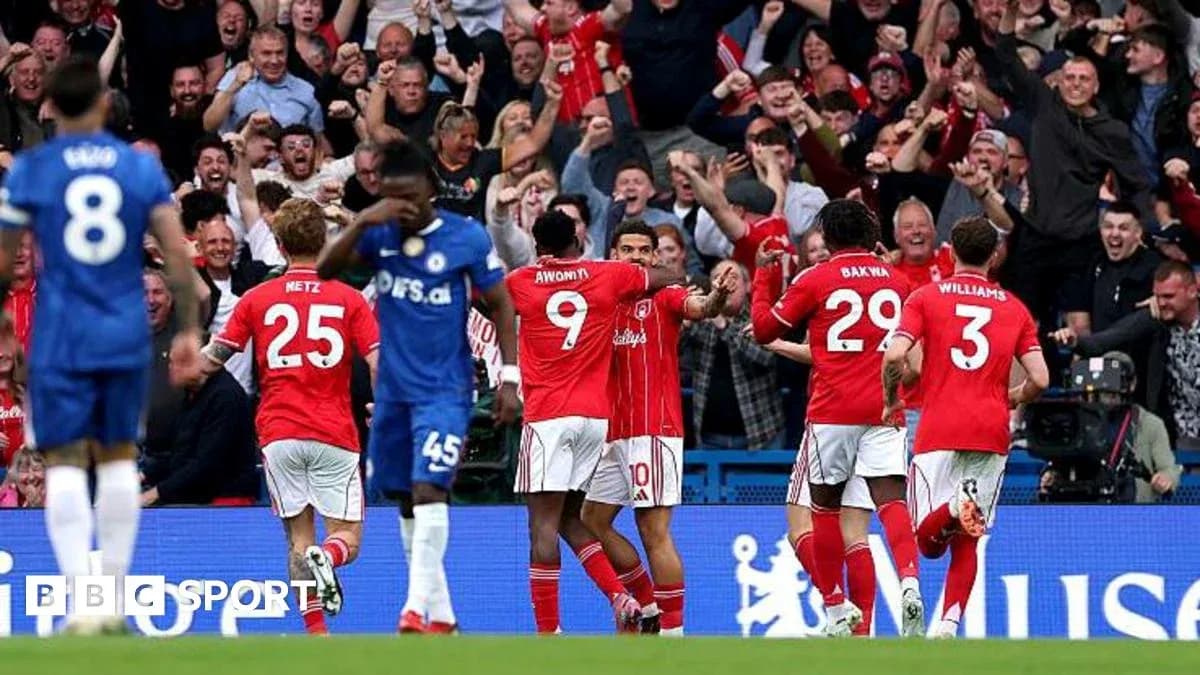 Players celebrating a goal with fans in stadium