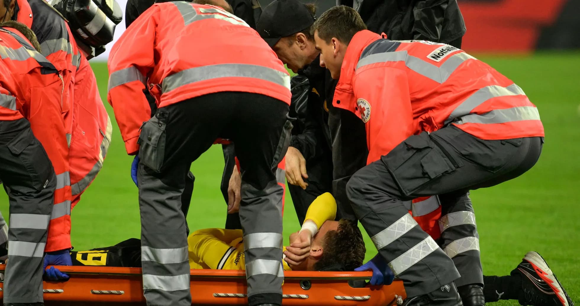 Medical team assisting injured player on stretcher