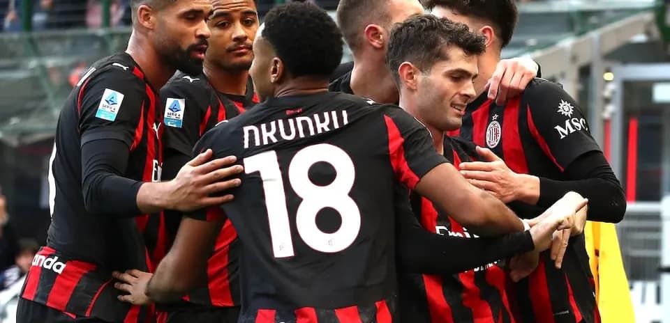 AC Milan players celebrating a goal together