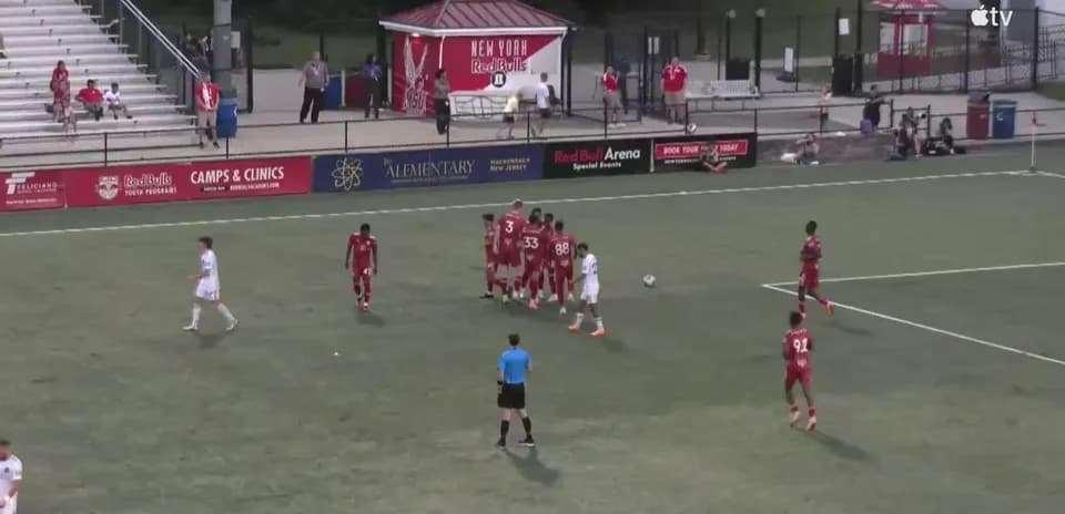 Players preparing for a free kick during match