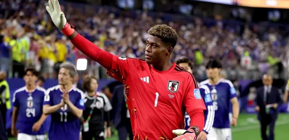 Japanese goalkeeper waving to fans after match
