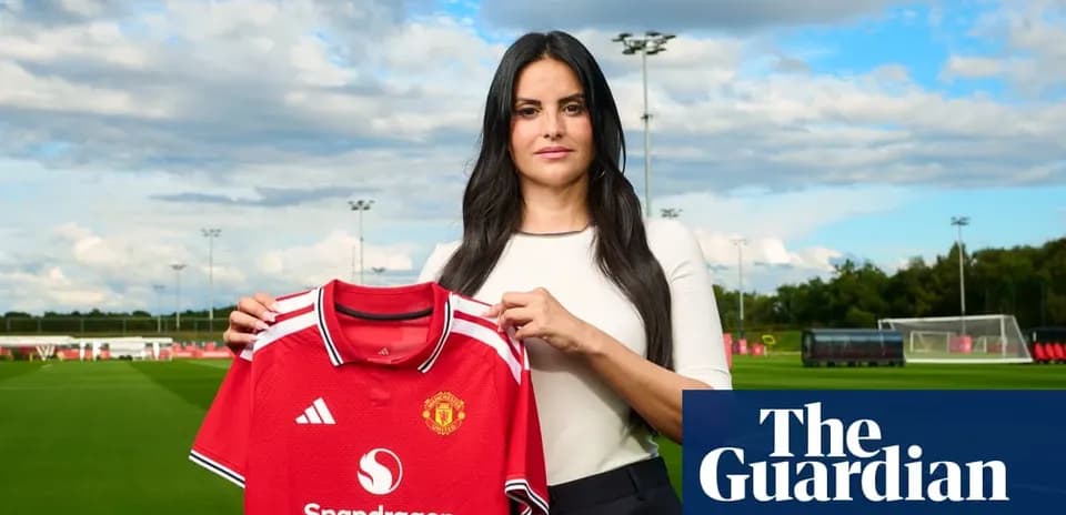 Woman holding Manchester United jersey at training ground