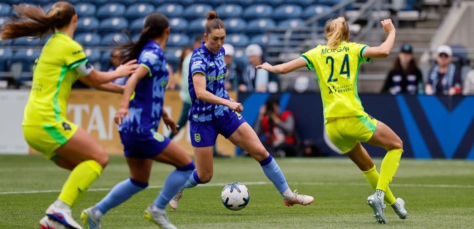 Seattle Reign FC players competing for the ball