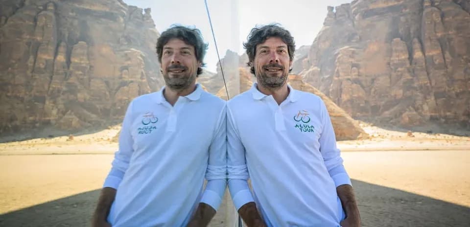 Man posing in front of desert landscape and mountains