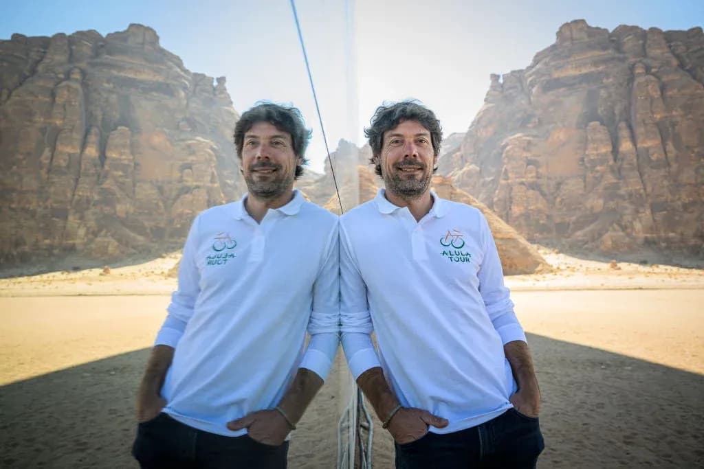 Man posing in front of desert landscape and mountains