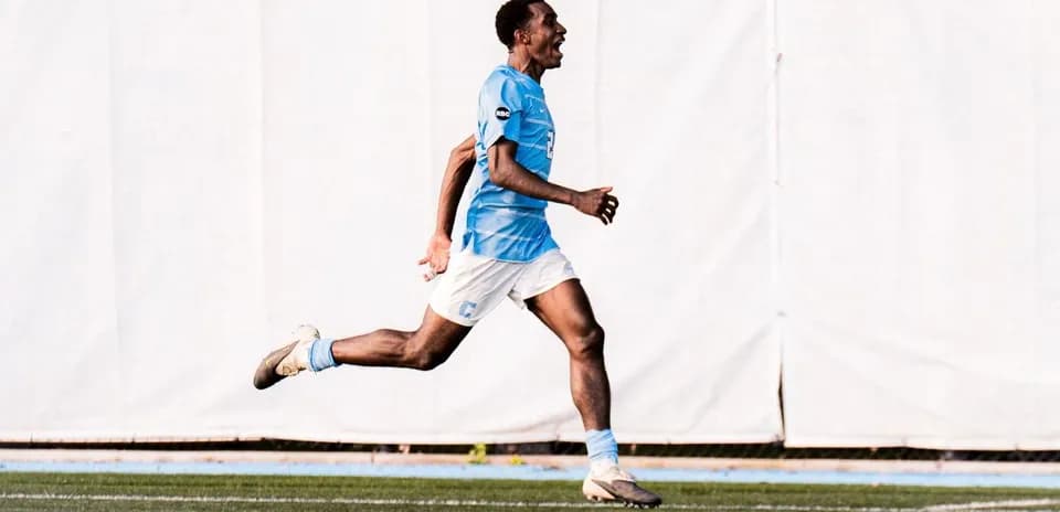 Player celebrating a goal while running on the field