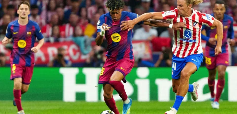 Barcelona player dribbling against Atletico Madrid defender