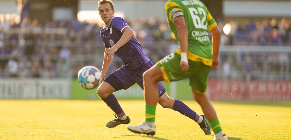 Player passing ball during Louisville City match