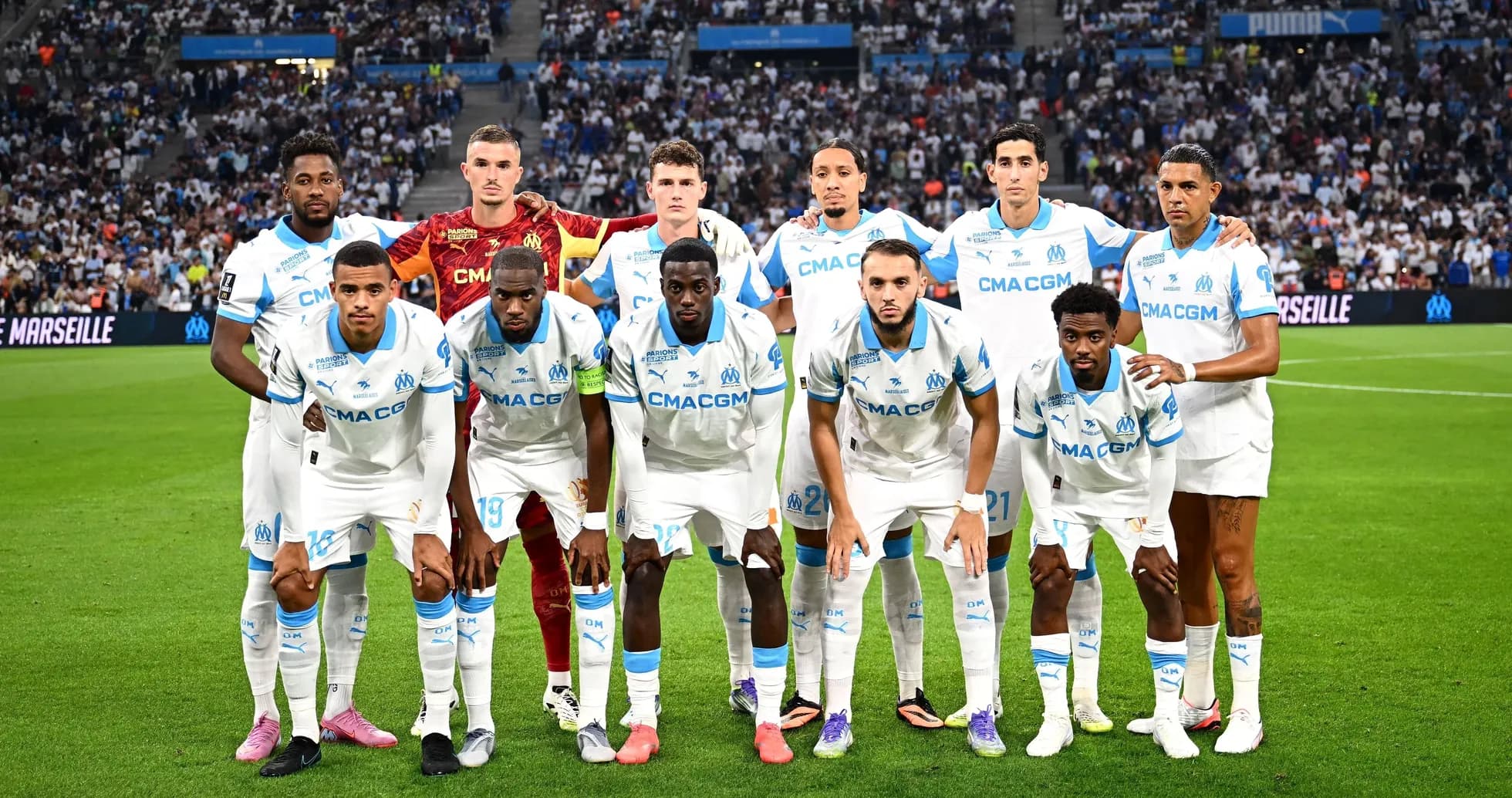 Olympique de Marseille team posing on the field