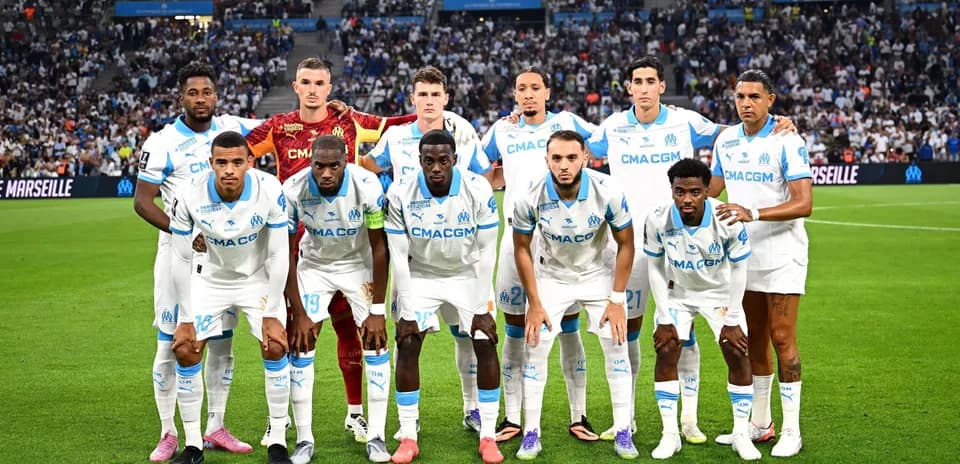 Olympique de Marseille team posing on the field
