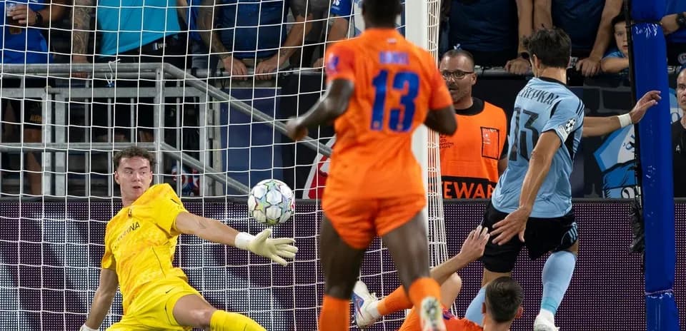 Goalkeeper attempting to save a shot on goal
