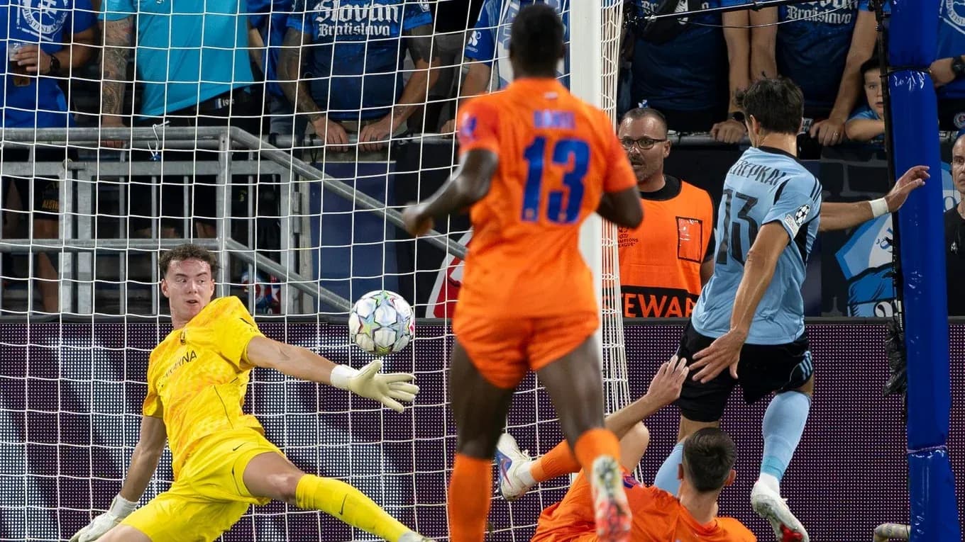 Goalkeeper attempting to save a shot on goal