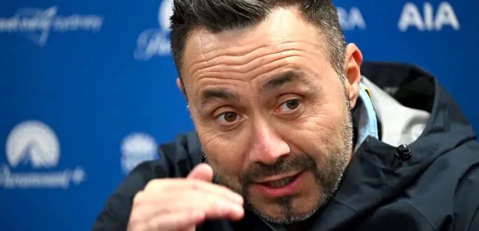 Manager speaking at press conference with hand gesture