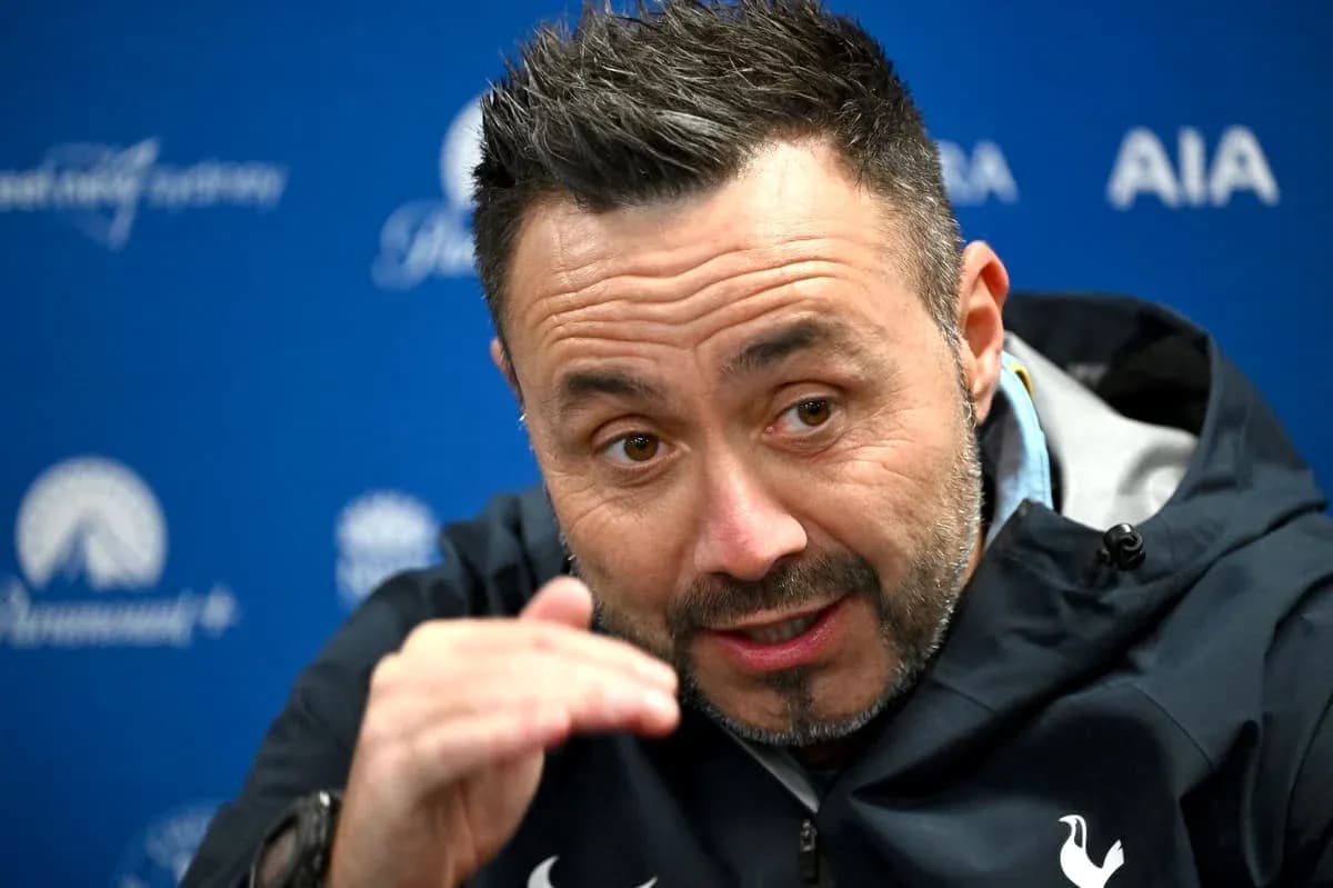 Manager speaking at press conference with hand gesture