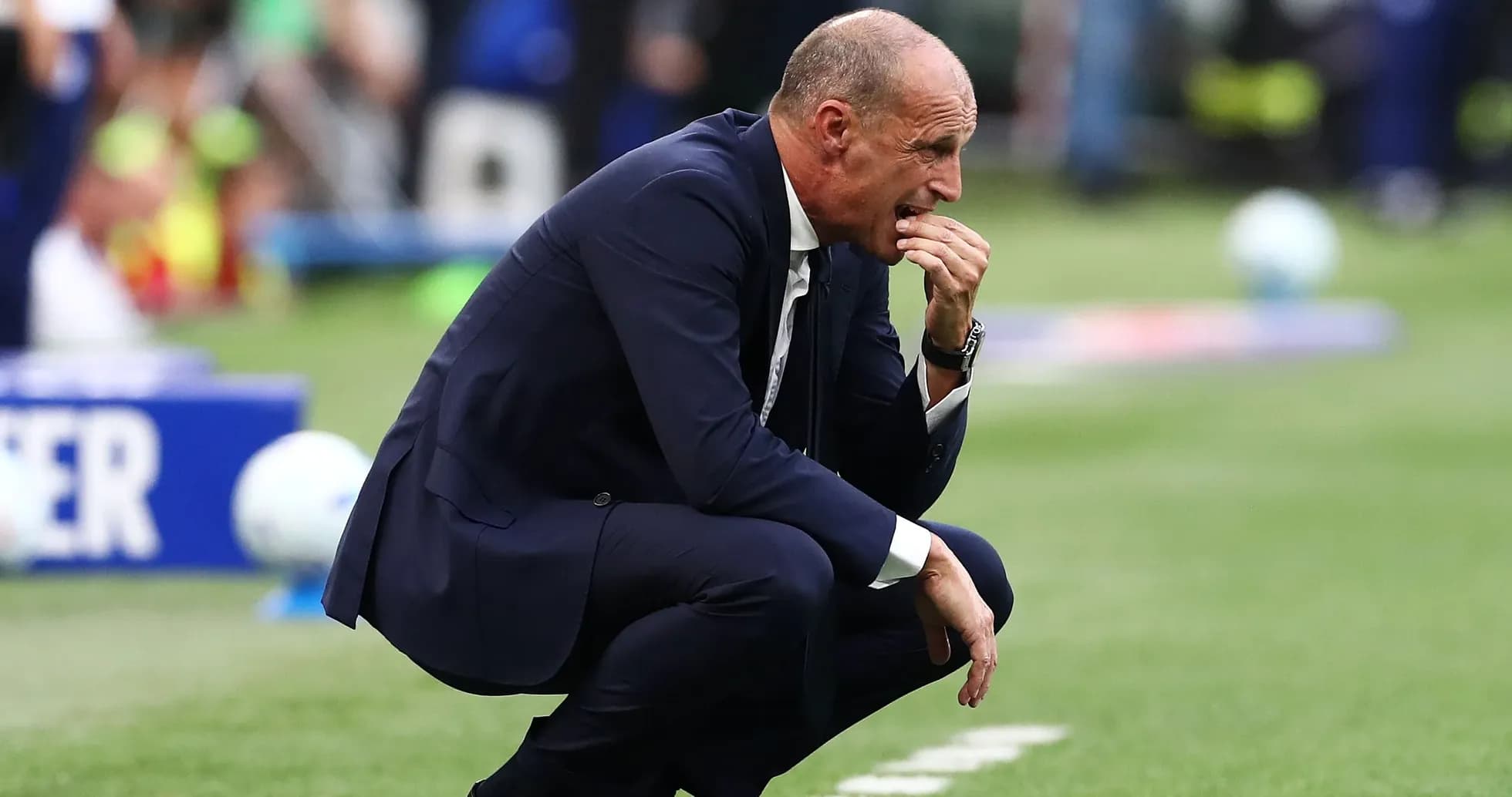 Coach crouched on sideline during a match