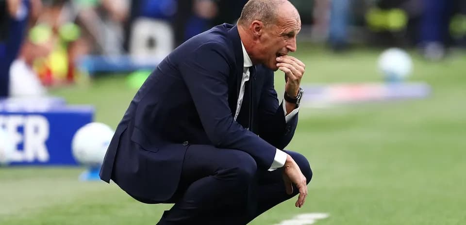 Coach crouched on sideline during a match
