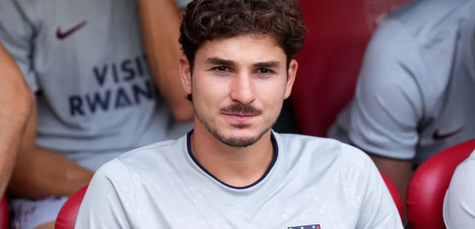 Player seated on bench during match warm-up