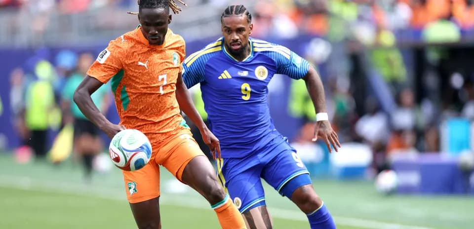 Player from Ivory Coast dribbling past opponent