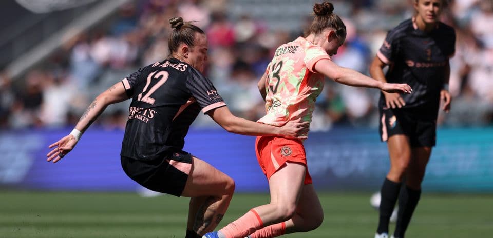Portland Thorns player tackling Utah Royals opponent