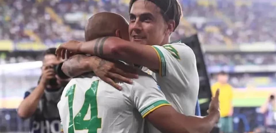 Two players embracing on the field after match