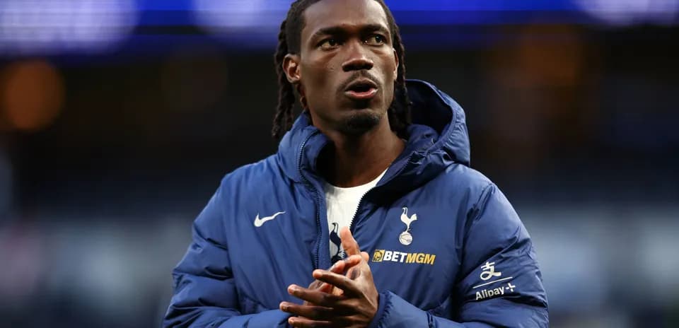 Player in Tottenham jacket during warm-up