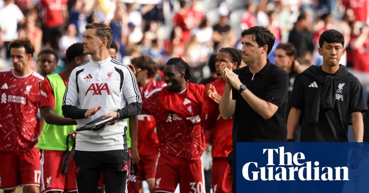 Liverpool players and staff applauding fans after match
