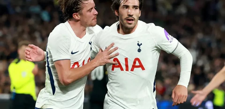 Two Tottenham players celebrating a goal together