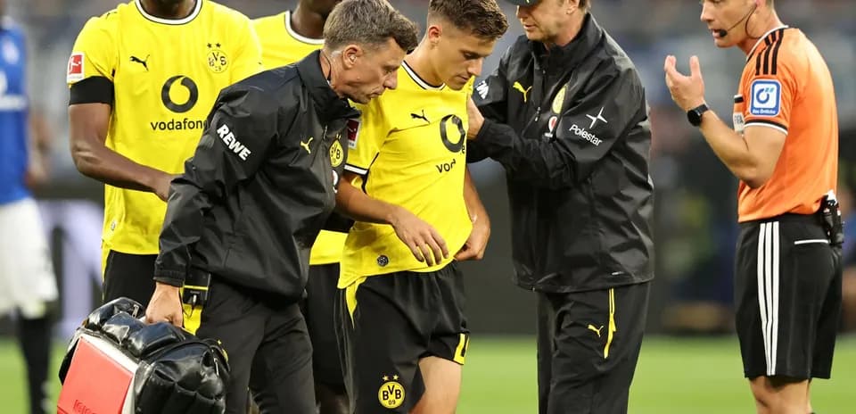 Borussia Dortmund players attending to injured teammate
