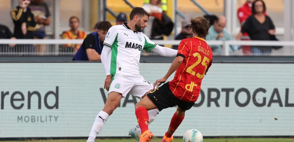 Sassuolo player challenging Lecce opponent for the ball