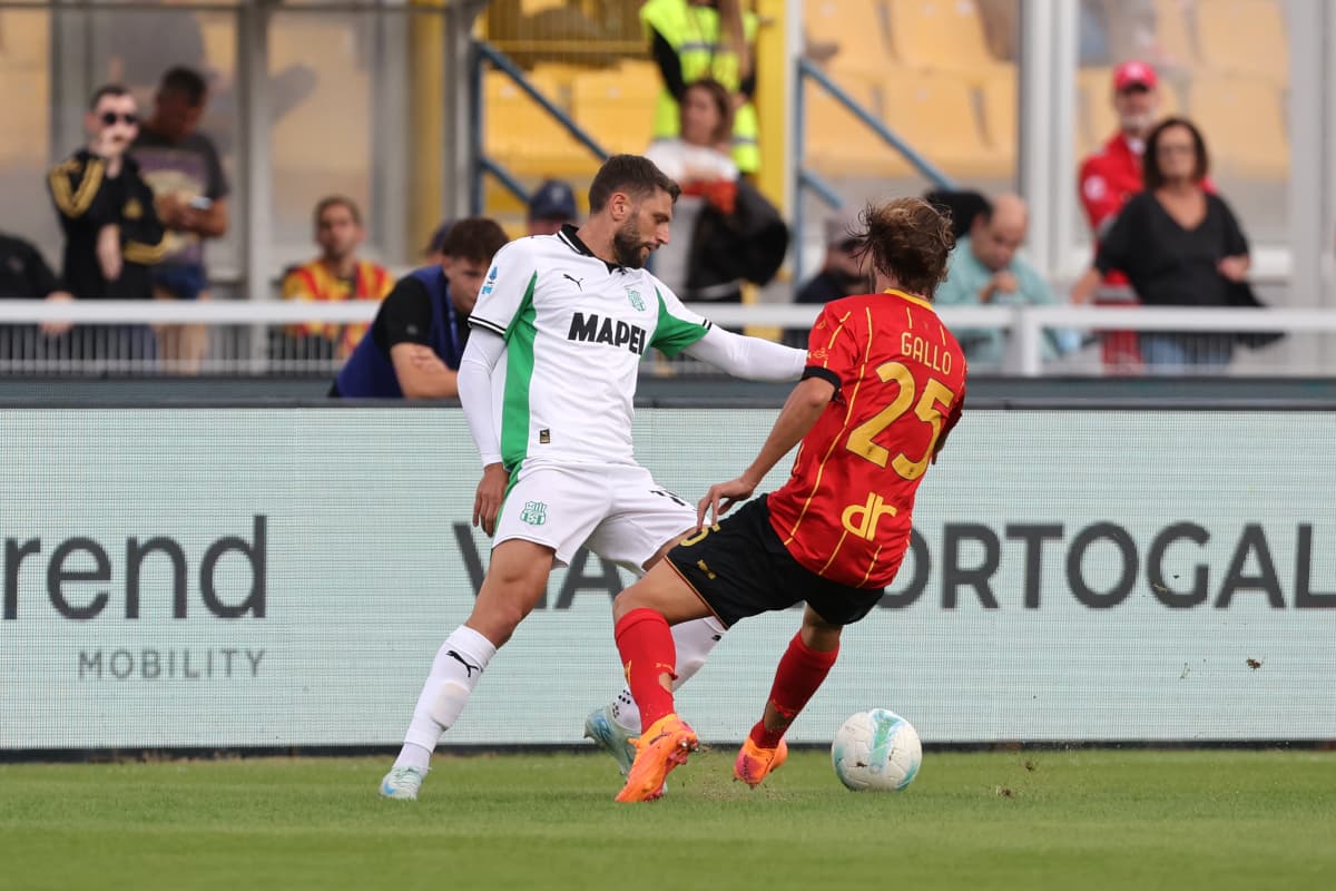 Sassuolo player challenging Lecce opponent for the ball