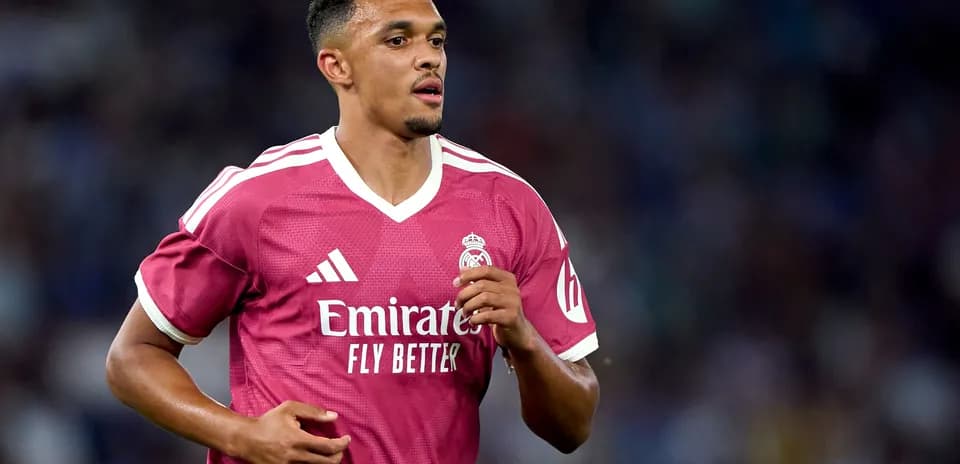 Player in pink Real Madrid jersey running on field