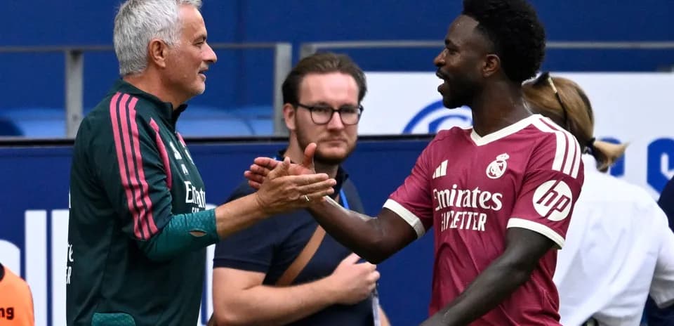 Coach and player shaking hands during match