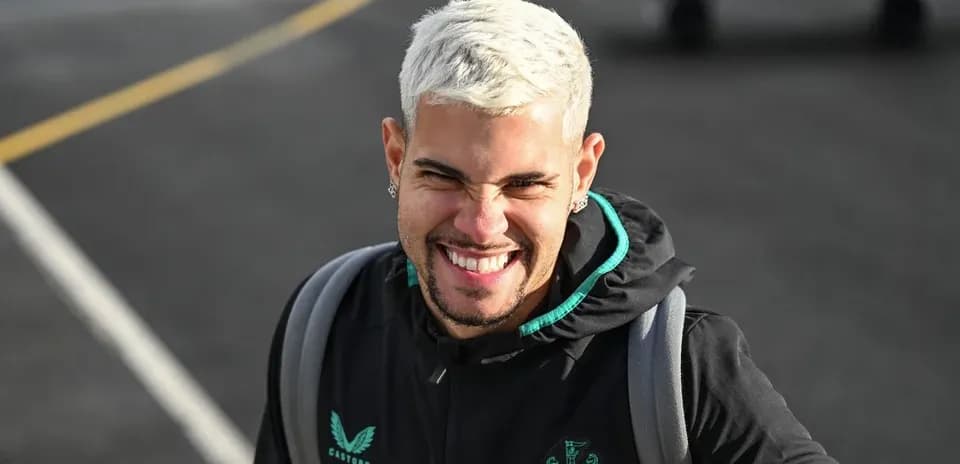 Player smiling while wearing Newcastle United jacket