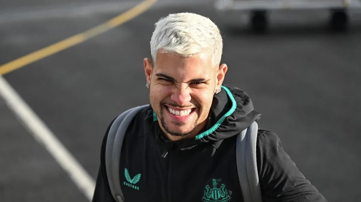 Player smiling while wearing Newcastle United jacket