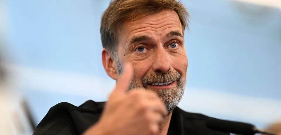 Manager giving a thumbs up at press conference
