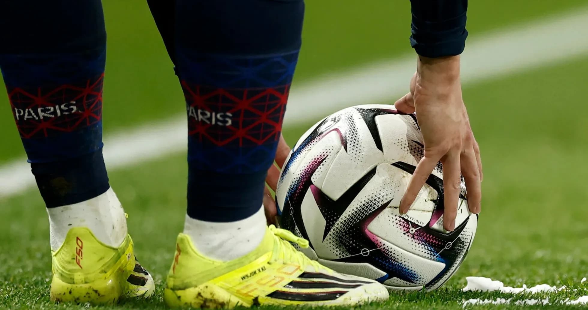 Player placing ball for a set piece on field