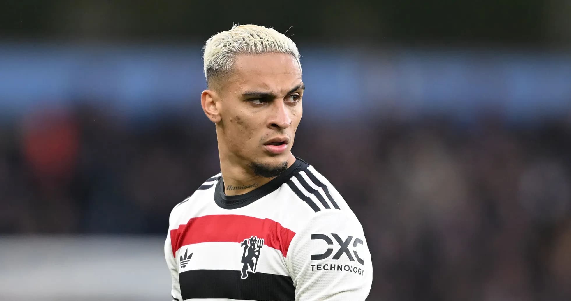 Player in striped jersey looking away on the pitch