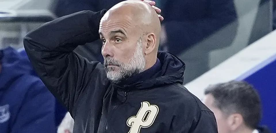 Coach with hand on head during match observation