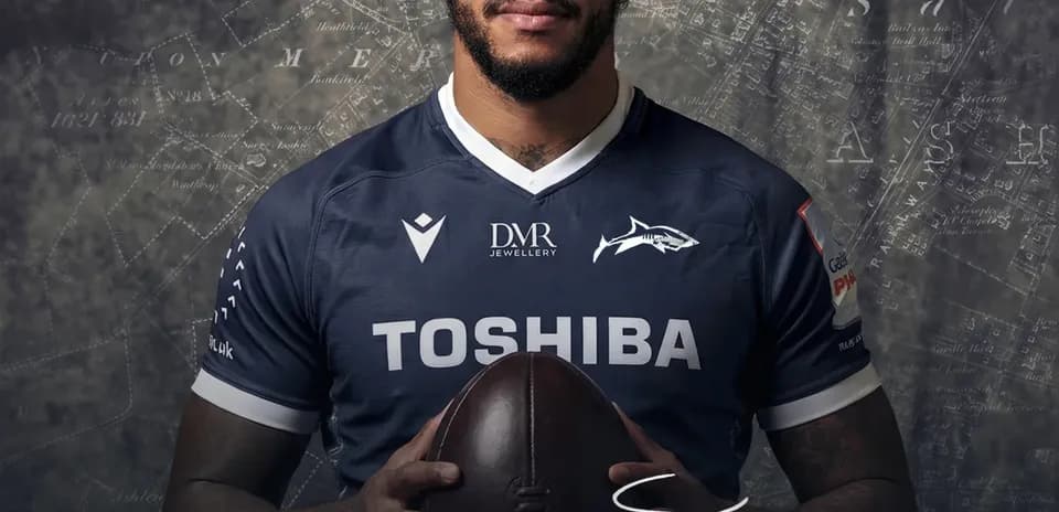 Courtney Lawes holding a rugby ball in jersey