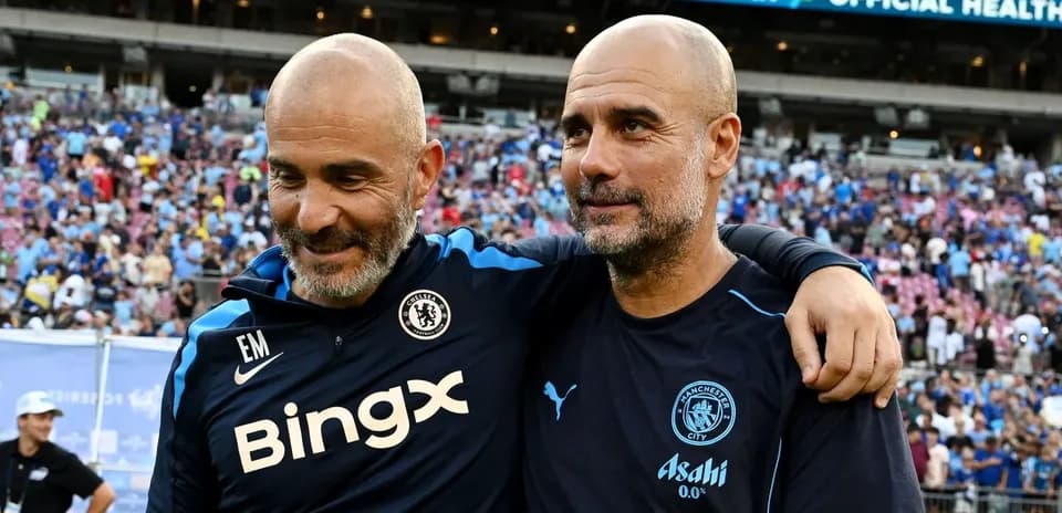 Two football managers smiling together after match
