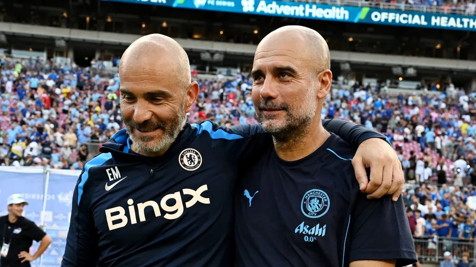 Two football managers smiling together after match