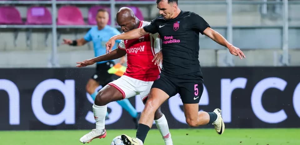Players competing for the ball in UEFA match
