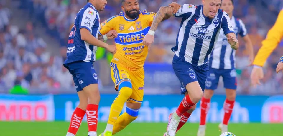 Monterrey players challenging Tigres UANL during match