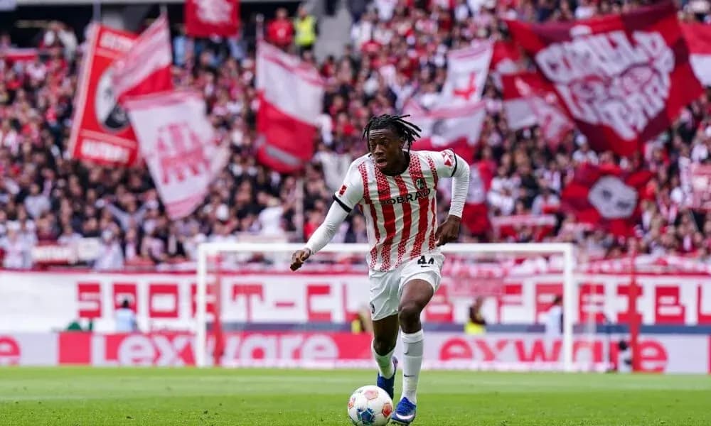 Player running with ball in front of cheering fans