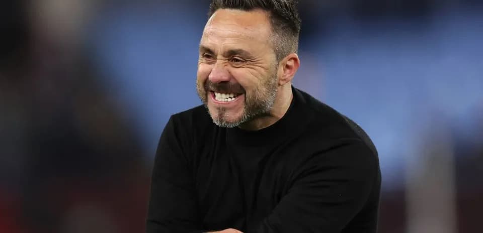 Coach smiling during match on the sideline