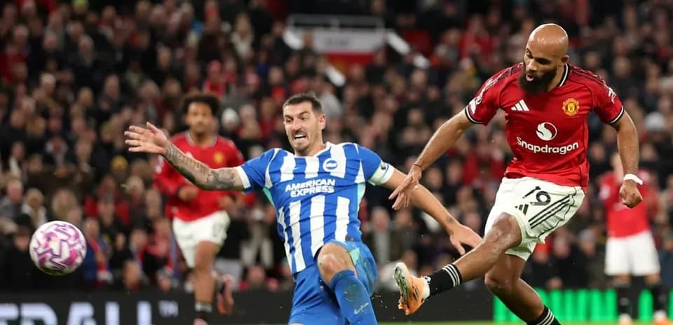 Brighton player tackling Manchester United player