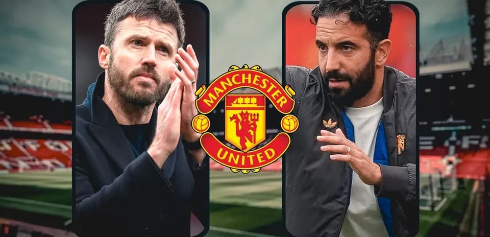 Two coaches discussing on the pitch at Old Trafford