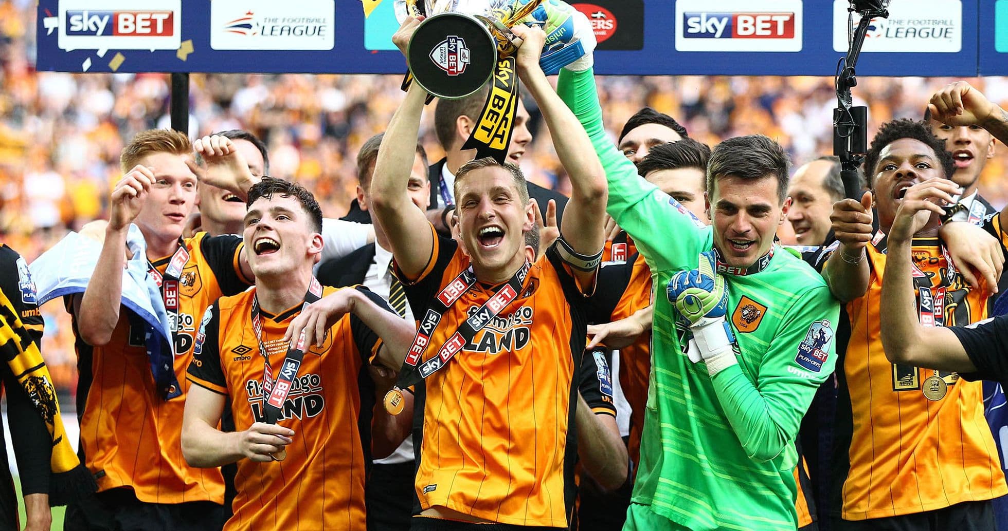Players celebrating with trophy after victory